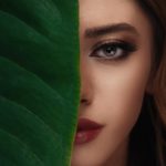 woman in red lipstick beside green textile