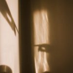 a shadow of a bowl and spoon on a wall